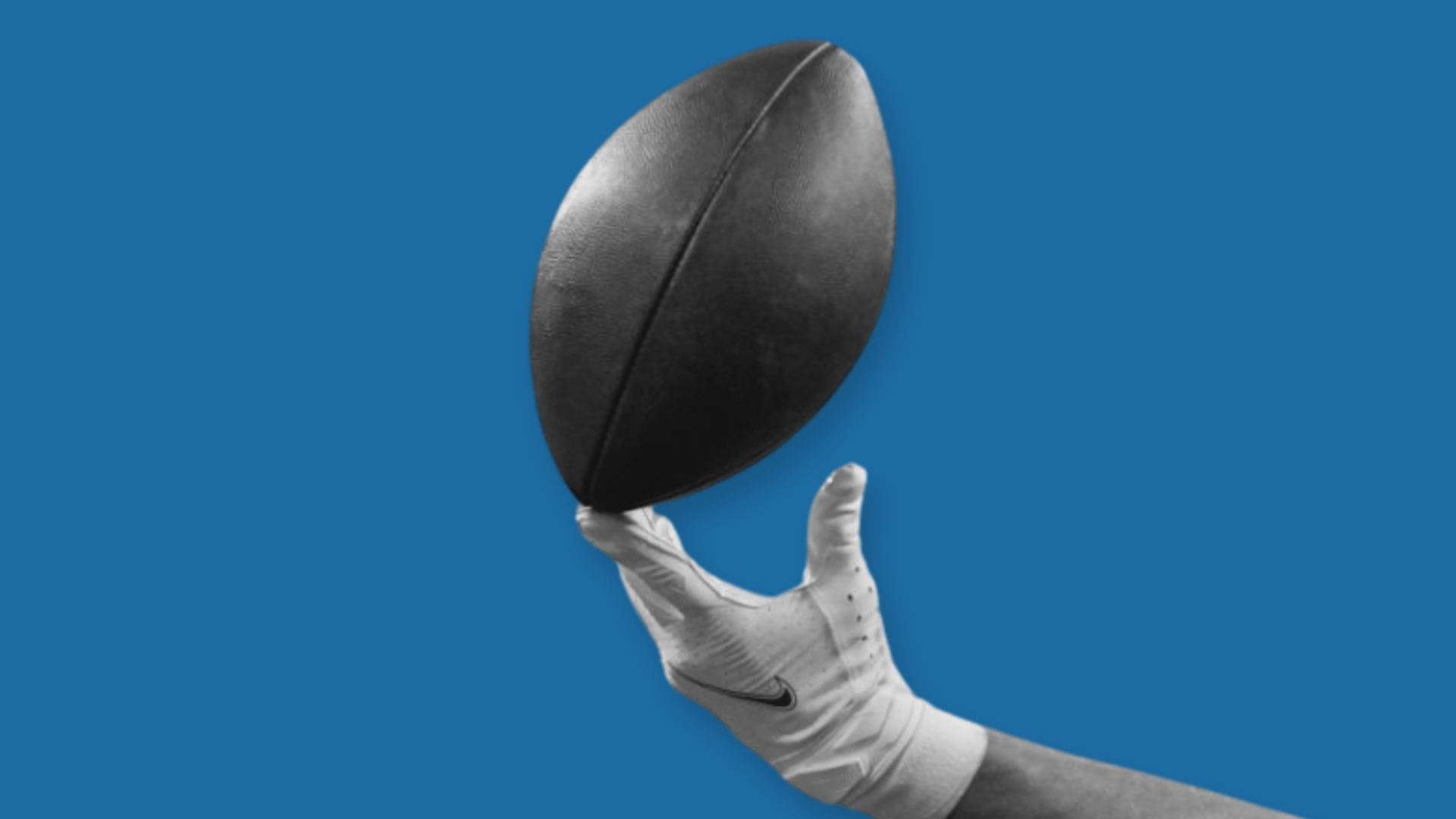NFL football player’s hand catching a ball, symbolizing the challenge of building lasting wealth after short careers.